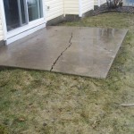 Before picture of a cracked concrete patio