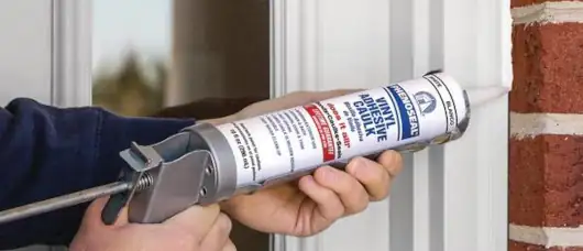 Applying waterproof caulk for energy-efficient and weatherproof window sealing.